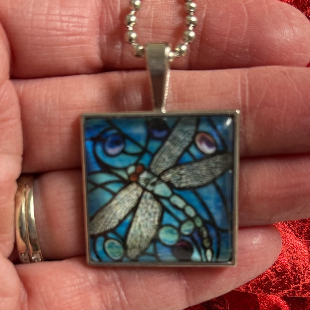 Dragonfly ball chain w/ 1” square pendant of blue  dragonfly.  Clear front. NIP